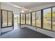 Sunlit Florida room features large windows, neutral carpet, and a ceiling fan for year-round enjoyment at 721 Polo Park Blvd, Davenport, FL 33897