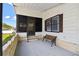 Cozy front porch with a bench, screen door, and brick accents offer a welcoming outdoor space at 721 Polo Park Blvd, Davenport, FL 33897