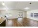 Spacious living area with wood flooring, bright lighting, and access to a screened lanai offers flexible living at 721 Polo Park Blvd, Davenport, FL 33897
