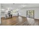 Bright and airy living room featuring wood flooring, white walls, and access to a screened-in porch at 721 Polo Park Blvd, Davenport, FL 33897