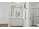 Bathroom with white vanity, decorative stained glass window, and glass door shower stall at 721 Polo Park Blvd, Davenport, FL 33897