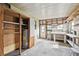 Spacious garage area with workbench, shelving, and door to the exterior at 721 Polo Park Blvd, Davenport, FL 33897