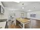 Well-lit kitchen featuring modern appliances, white cabinetry, and a kitchen island at 721 Polo Park Blvd, Davenport, FL 33897