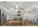 Modern kitchen with stainless steel appliances, dining area, and bright lighting at 721 Polo Park Blvd, Davenport, FL 33897