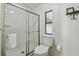 White toilet and glass enclosed shower for a neat, bright bathroom at 721 Polo Park Blvd, Davenport, FL 33897