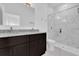 Bathroom showcasing double vanity, dark wood cabinets, and frameless glass shower at 773 Marion Oaks Pass, Ocala, FL 34473