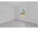 Bright bedroom with a window view of the landscape and sleek tile flooring at 773 Marion Oaks Pass, Ocala, FL 34473