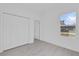 Bright bedroom features tile flooring, a window, and closet for ample storage at 773 Marion Oaks Pass, Ocala, FL 34473