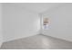 Bright bedroom with a window view of the landscape and sleek tile flooring at 773 Marion Oaks Pass, Ocala, FL 34473