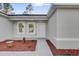 Inviting front entrance with tasteful landscaping and a modern, neutral-colored exterior at 773 Marion Oaks Pass, Ocala, FL 34473
