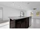 Kitchen island featuring granite countertop with sink, dishwasher, and dark brown cabinetry at 773 Marion Oaks Pass, Ocala, FL 34473