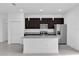 Stylish kitchen featuring a large island, granite countertops, stainless steel appliances, and ample cabinet space at 773 Marion Oaks Pass, Ocala, FL 34473