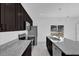 Modern kitchen boasts granite counters, stainless appliances, and sleek, dark cabinetry at 773 Marion Oaks Pass, Ocala, FL 34473