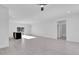 Bright, open-concept living room featuring tile floors and a view to the kitchen at 773 Marion Oaks Pass, Ocala, FL 34473