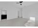 Spacious bedroom with ceiling fan, bathroom access, and sleek tile flooring at 773 Marion Oaks Pass, Ocala, FL 34473