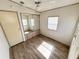 Bedroom featuring plank flooring, ceiling fan, closet with mirrored doors and natural light at 9000 Us Highway 192 # 835, Clermont, FL 34714