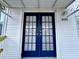 The home's entrance features stylish blue double doors with glass panels and silver hardware at 9000 Us Highway 192 # 835, Clermont, FL 34714