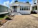 The home's exterior view highlights a covered porch, landscaped garden and driveway at 9000 Us Highway 192 # 835, Clermont, FL 34714