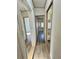 Hallway featuring laminate floors, a closet, and access to bedrooms at 9000 Us Highway 192 # 835, Clermont, FL 34714