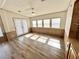Bright living room with wood-look floors and access to the exterior through stylish glass doors at 9000 Us Highway 192 # 835, Clermont, FL 34714