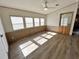 Bright living room featuring wood-look floors, neutral walls, and natural light at 9000 Us Highway 192 # 835, Clermont, FL 34714