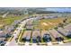 Aerial view of a residential neighborhood near a lake and green spaces at 917 Carmillion Ct, Groveland, FL 34736
