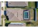 Aerial view of a home with a private screened-in pool and fenced backyard at 917 Carmillion Ct, Groveland, FL 34736