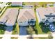 Aerial view of a two-story home with well-manicured front yard and a paver driveway at 917 Carmillion Ct, Groveland, FL 34736