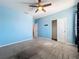 Bedroom featuring neutral carpet, a ceiling fan, and closet at 917 Carmillion Ct, Groveland, FL 34736