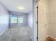 A view of a light purple bedroom showcasing a closet, carpet and window at 917 Carmillion Ct, Groveland, FL 34736