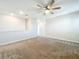 Open bonus room features neutral walls and carpet, plus a ceiling fan at 917 Carmillion Ct, Groveland, FL 34736