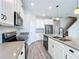 Modern kitchen featuring white cabinetry, stainless steel appliances, and a functional kitchen island at 917 Carmillion Ct, Groveland, FL 34736