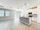 Bright kitchen featuring a center island with decorative tile, modern appliances, and ample cabinet space at 917 Carmillion Ct, Groveland, FL 34736