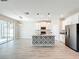 Open kitchen with decorative island, stainless appliances, and lots of natural light at 917 Carmillion Ct, Groveland, FL 34736