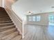 A view of the spacious living area that features wood floors and large windows for ample light at 917 Carmillion Ct, Groveland, FL 34736