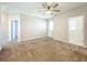 A spacious main bedroom with carpet and entrances to the bathroom and closets at 917 Carmillion Ct, Groveland, FL 34736