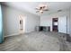 A view of the spacious bedroom with a ceiling fan and connecting bathrooms at 917 Carmillion Ct, Groveland, FL 34736