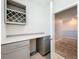 Office area featuring a built-in desk and wine rack, with gray cabinetry at 917 Carmillion Ct, Groveland, FL 34736