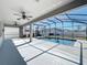 A view of the beautiful backyard pool, with the screened-in lanai and ceiling fans at 917 Carmillion Ct, Groveland, FL 34736