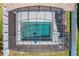 Aerial view of a screened-in pool with clear blue water, surrounded by a concrete deck and green grass at 917 Carmillion Ct, Groveland, FL 34736