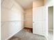 A compact walk-in closet with carpet and functional shelving on white walls at 917 Carmillion Ct, Groveland, FL 34736