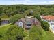 Aerial shot of a large brick home surrounded by lush greenery and ponds at 9501 Tavistock Rd, Orlando, FL 32827