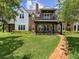 A large home with brick and siding exterior, covered porch, and second story balcony at 9501 Tavistock Rd, Orlando, FL 32827