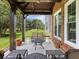 Inviting back porch with outdoor seating area, perfect for enjoying the serene green surroundings at 9501 Tavistock Rd, Orlando, FL 32827