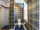 Unique bathroom with shower, patterned wallpaper, blue tile floors, and a window, offering natural light and character at 9501 Tavistock Rd, Orlando, FL 32827