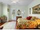 Inviting bedroom with hardwood floors, floral bedding, and French doors, offering a comfortable and stylish retreat at 9501 Tavistock Rd, Orlando, FL 32827