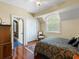 Comfortable bedroom with a patterned comforter, wood floors, and a closet for ample storage, providing a cozy retreat at 9501 Tavistock Rd, Orlando, FL 32827