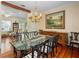 Elegant dining room featuring a glass-top table, ornate chairs, and hardwood floors at 9501 Tavistock Rd, Orlando, FL 32827