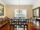 Elegant dining room with glass table, decorative chairs, and sophisticated chandelier at 9501 Tavistock Rd, Orlando, FL 32827