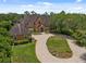 A charming two-story brick home features a beautifully landscaped front yard, garage and a curved driveway at 9501 Tavistock Rd, Orlando, FL 32827